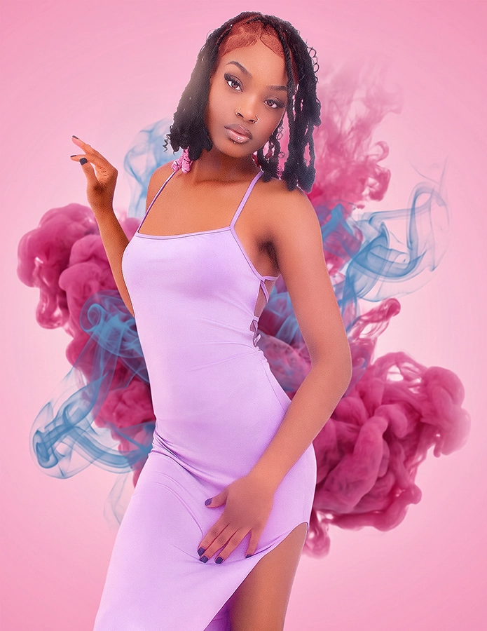 Young woman in a lavender slip dress posing against pink background with swirling magenta and teal smoke, fashion portrait