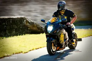 Renaldo Creative photo of a Black rider in black and yellow gear on a Suzuki sportbike riding on a sunlit road, portfolio