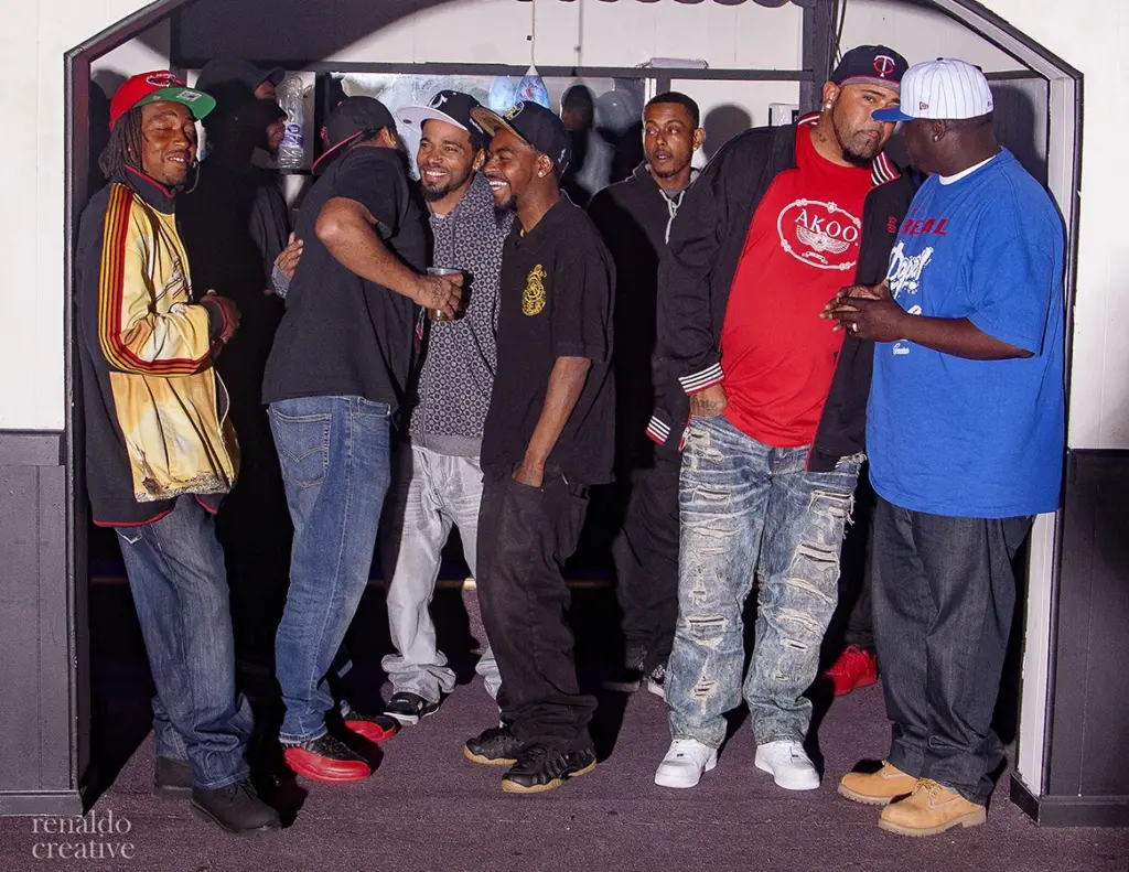 Group of men in casual attire gathered together at an event